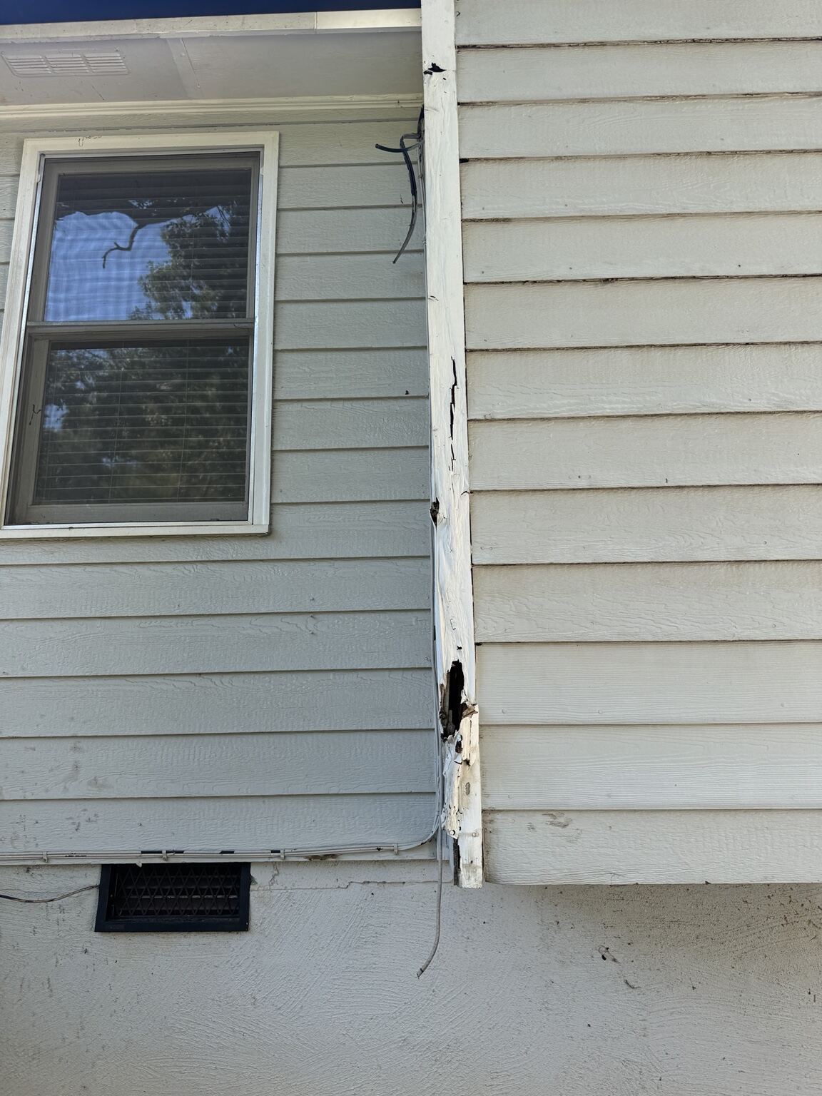 Corrected roofline corner with new soffit, fascia and clean gutter line