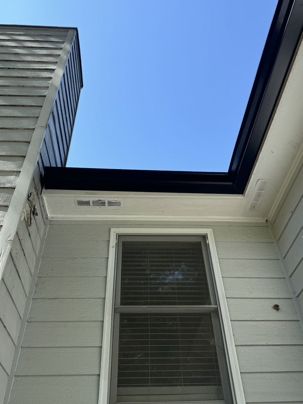 Finished fascia, soffit and siding detail on a white home