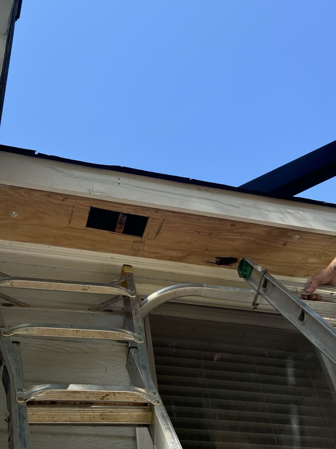 New fascia being set and wrapped along the roof edge