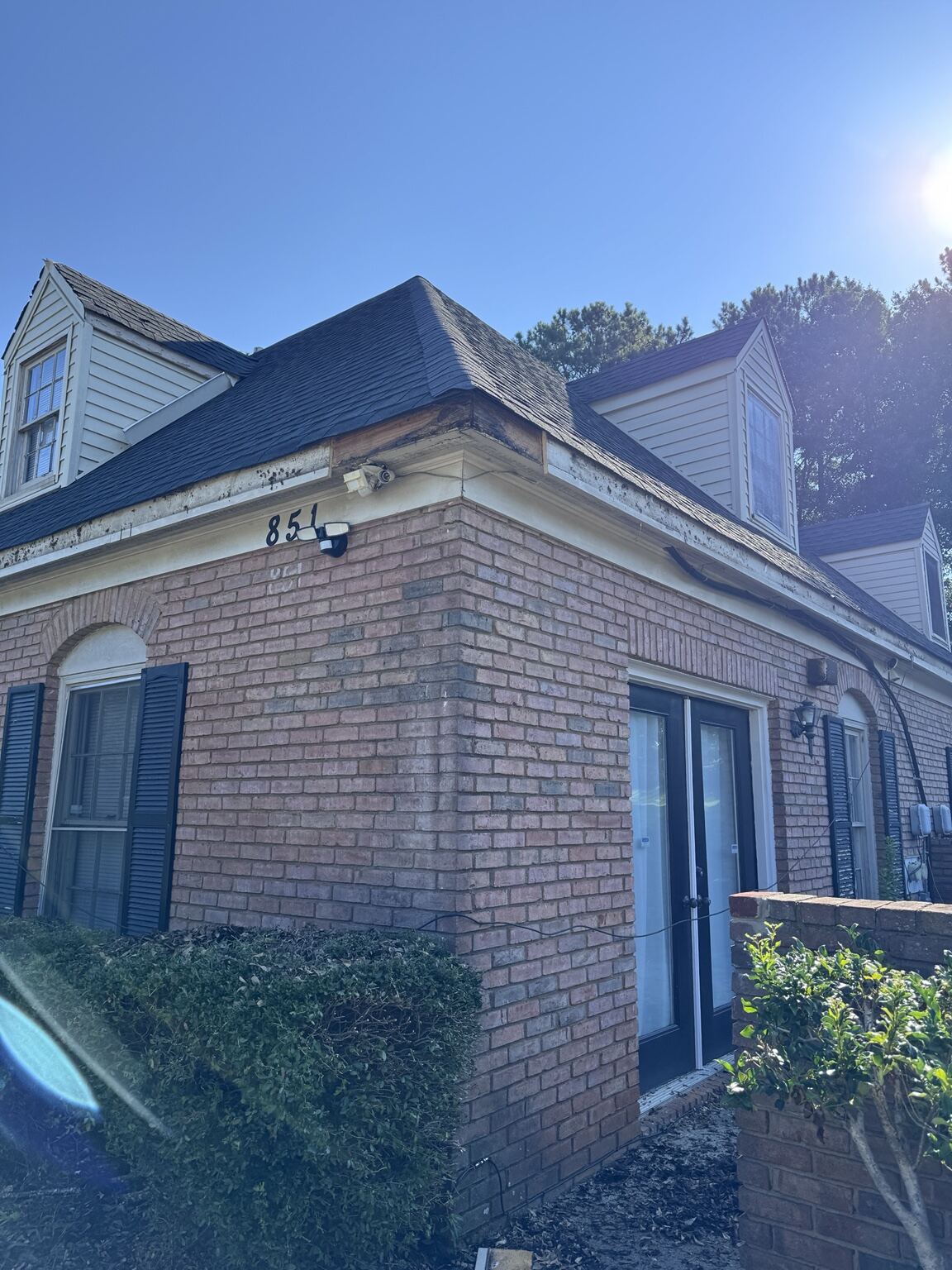 Same brick quadplex building after new fascia, gutter and downspout work