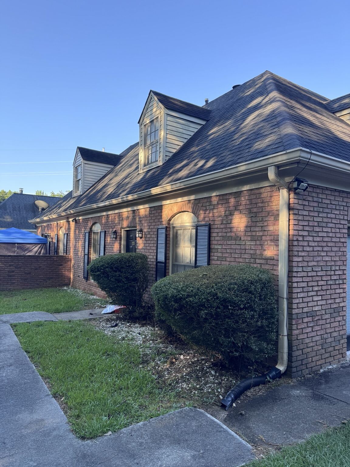 Corner of a brick apartment building with new gutter run