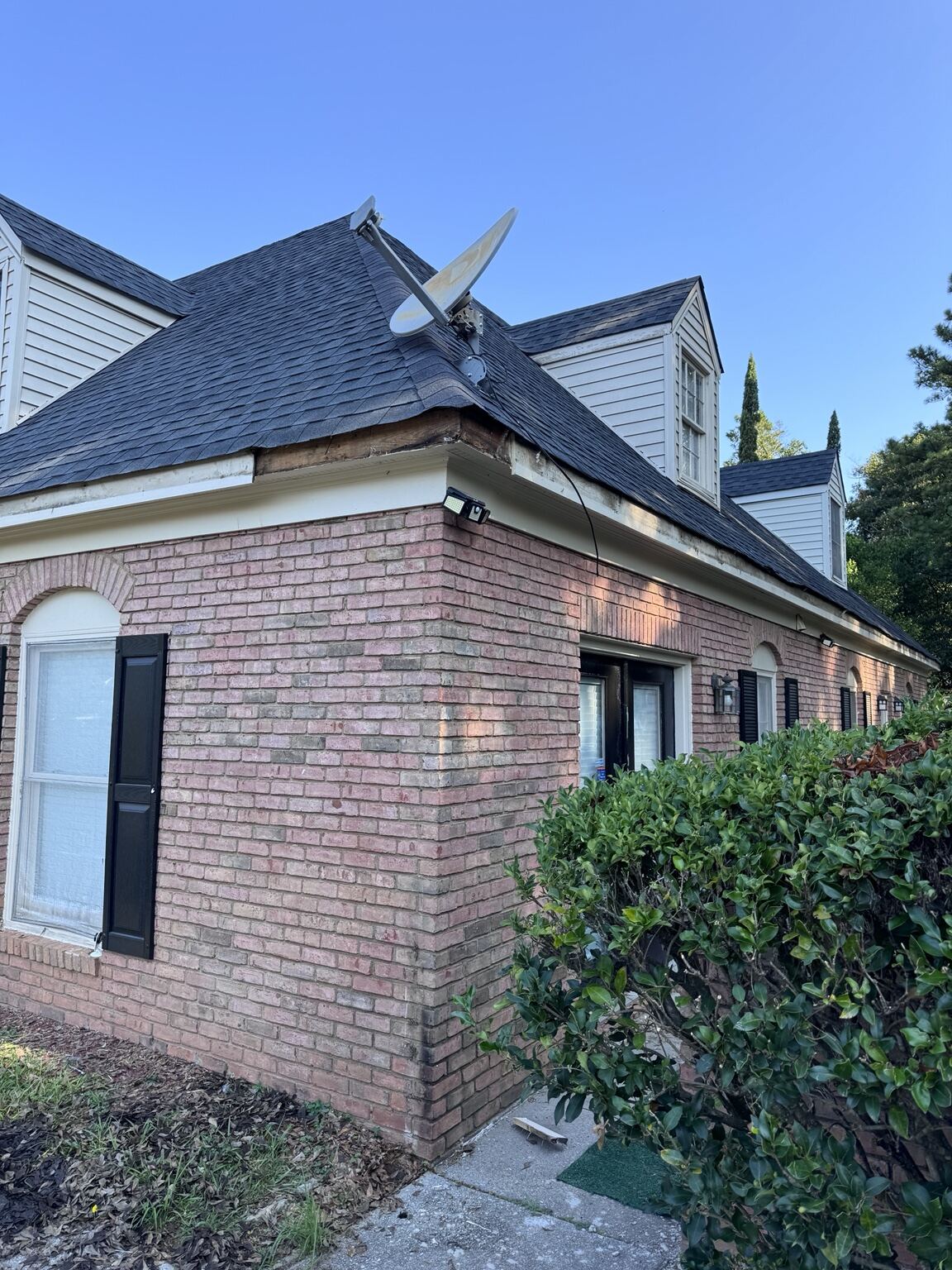 Roofline of a brick multifamily building after gutter service