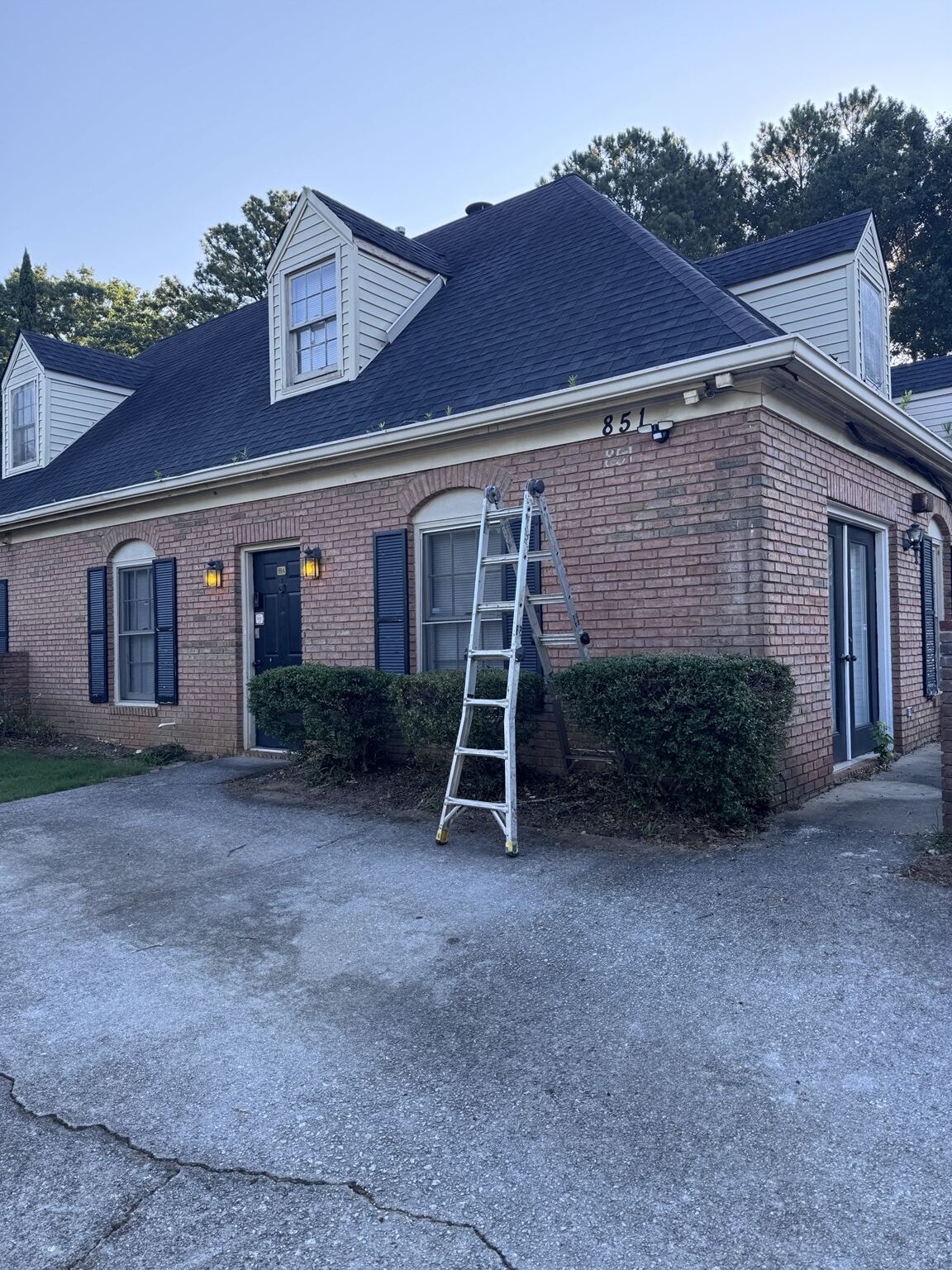 Ladder staged at a brick apartment building during service